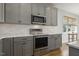 Close up of kitchen with stainless steel appliances and gray cabinets at 221 Old Hickory Dr, Raleigh, NC 27603