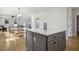 Bright kitchen with a gray island, marble countertops, wood floors, and an open floor plan at 221 Old Hickory Dr, Raleigh, NC 27603