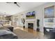 Bright open-concept living room with hardwood floors, fireplace, and view into kitchen at 221 Old Hickory Dr, Raleigh, NC 27603