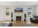 Bright living room boasts a fireplace with tile surround, hardwood floors, and natural light at 221 Old Hickory Dr, Raleigh, NC 27603