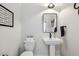 Stylish powder room with modern fixtures, a pedestal sink, and elegant decor at 221 Old Hickory Dr, Raleigh, NC 27603