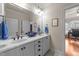 Double vanity bathroom with white cabinets and a view of the home office at 255 Dupree Rd, Willow Springs, NC 27592