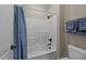 Clean bathroom with a shower/tub combo and blue accents at 255 Dupree Rd, Willow Springs, NC 27592