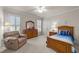 Guest bedroom with wood furniture and a comfortable recliner at 255 Dupree Rd, Willow Springs, NC 27592