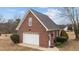 Detached brick garage with white door at 255 Dupree Rd, Willow Springs, NC 27592
