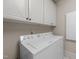 Bright laundry room with washer, dryer, and ample cabinetry at 255 Dupree Rd, Willow Springs, NC 27592