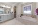 Elegant main bathroom featuring a soaking tub and double vanity at 255 Dupree Rd, Willow Springs, NC 27592