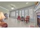Sunroom featuring two armchairs, a fireplace and multiple windows at 255 Dupree Rd, Willow Springs, NC 27592