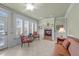 Bright sunroom with fireplace, comfortable seating, and large windows at 255 Dupree Rd, Willow Springs, NC 27592