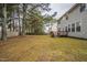 Large backyard with a wooden deck and mature trees at 3124 Gross Ave, Wake Forest, NC 27587
