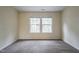 Well-lit bedroom with two large windows and carpet flooring at 3124 Gross Ave, Wake Forest, NC 27587