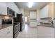 Modern kitchen with stainless steel appliances and granite countertops at 3124 Gross Ave, Wake Forest, NC 27587