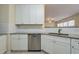 White shaker cabinets, granite countertops, and stainless steel dishwasher at 3124 Gross Ave, Wake Forest, NC 27587