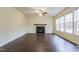 Living room with dark hardwood floors, fireplace, and multiple windows at 3124 Gross Ave, Wake Forest, NC 27587