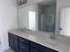 Bathroom featuring double sink vanity with quartz countertop, dark cabinets, and tiled shower at 3275 Roundly Rd # 10, New Hill, NC 27562