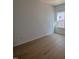 Sunny bedroom with beautiful hardwood floors, white walls, and a bright window at 3275 Roundly Rd # 10, New Hill, NC 27562