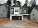 Two-story home with gray siding, white accents, and a two-car garage at 3275 Roundly Rd # 10, New Hill, NC 27562