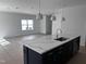 Kitchen island featuring quartz countertop, stainless steel sink and modern pendant lighting at 3275 Roundly Rd # 10, New Hill, NC 27562
