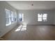 Open concept living room with wood floors and multiple windows offering lots of natural light at 3275 Roundly Rd # 10, New Hill, NC 27562
