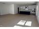 Open living space with modern kitchen with an island and large living area with windows at 3275 Roundly Rd # 10, New Hill, NC 27562