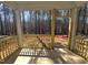 View from screened-in porch with unfinished wood railings looking out to wooded area at 3275 Roundly Rd # 10, New Hill, NC 27562