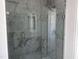 Modern shower featuring marble-look tile and glass door at 3275 Roundly Rd # 10, New Hill, NC 27562