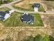 Aerial perspective of a development with newly built homes featuring manicured lawns and convenient road access at 38 Hewitt Woods Dr, Clayton, NC 27527