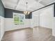 Dining room featuring decorative wall trim, wood floors and modern light fixture at 38 Hewitt Woods Dr, Clayton, NC 27527