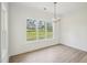 Sunlit dining room features wood floors and a large window with a picturesque view at 38 Hewitt Woods Dr, Clayton, NC 27527