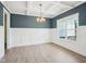 Dining room featuring decorative wall trim, wood floors and modern light fixture at 38 Hewitt Woods Dr, Clayton, NC 27527
