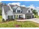 Attractive two-story home with a combination of stone and white siding, a two-car garage, and manicured front lawn at 38 Hewitt Woods Dr, Clayton, NC 27527