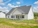 Bright, newly built single-Gathering home featuring white siding, a covered patio, and a well-manicured lawn at 38 Hewitt Woods Dr, Clayton, NC 27527