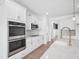 Bright kitchen boasts stainless steel appliances, white cabinets, and granite countertops at 38 Hewitt Woods Dr, Clayton, NC 27527