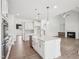 Modern kitchen boasts a white island with sink, stainless appliances, and eat in nook at 38 Hewitt Woods Dr, Clayton, NC 27527