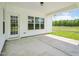 Covered back patio with white siding and view of greenery at 38 Hewitt Woods Dr, Clayton, NC 27527