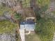 Overhead shot of a home with a gray roof, back deck, surrounded by trees, with a driveway and small backyard at 4224 Sancroft Dr, Apex, NC 27539