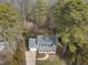 Aerial view of a home with a gray roof, white porch, surrounded by lush trees and a well-kept lawn at 4224 Sancroft Dr, Apex, NC 27539
