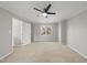 Well-lit bedroom featuring carpet, ceiling fan and an open door to a bathroom at 4224 Sancroft Dr, Apex, NC 27539
