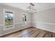Dining room with hardwood floors, wainscotting and windows with neighborhood views at 4224 Sancroft Dr, Apex, NC 27539