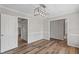 Bright dining room featuring wood floors, neutral walls, detailed trim, and a modern light fixture at 4224 Sancroft Dr, Apex, NC 27539