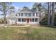 Lovely two-story home featuring a welcoming front porch with white railings and a well-manicured lawn at 4224 Sancroft Dr, Apex, NC 27539
