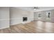 Living room with wood floors, fireplace and bright windows overlooking the lawn at 4224 Sancroft Dr, Apex, NC 27539