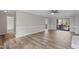Spacious living room with wood floors, ceiling fan, and sliding glass doors to deck at 4224 Sancroft Dr, Apex, NC 27539