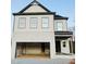 Two-story house with light gray brick and gray trim, featuring a two-car garage at 4420 Darius Lane # 37, Fuquay Varina, NC 27526