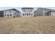View of a expansive backyard with new sod and the rear exterior of a grey two-story home at 45 Nimble Way # 180, Clayton, NC 27520