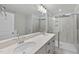 Bright bathroom featuring double sinks, shower, and a glass door at 45 Nimble Way # 180, Clayton, NC 27520