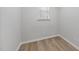 Bright bedroom with a window, wood-look flooring, and minimalist decor at 45 Nimble Way # 180, Clayton, NC 27520