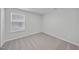 Neutral bedroom with beige carpet and a window, offering a serene and comfortable space at 45 Nimble Way # 180, Clayton, NC 27520