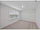 Neutral bedroom with beige carpet and a window, offering a serene and comfortable space at 45 Nimble Way # 180, Clayton, NC 27520