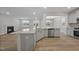 Kitchen with light countertops and an island that opens to living and dining areas at 45 Nimble Way # 180, Clayton, NC 27520
